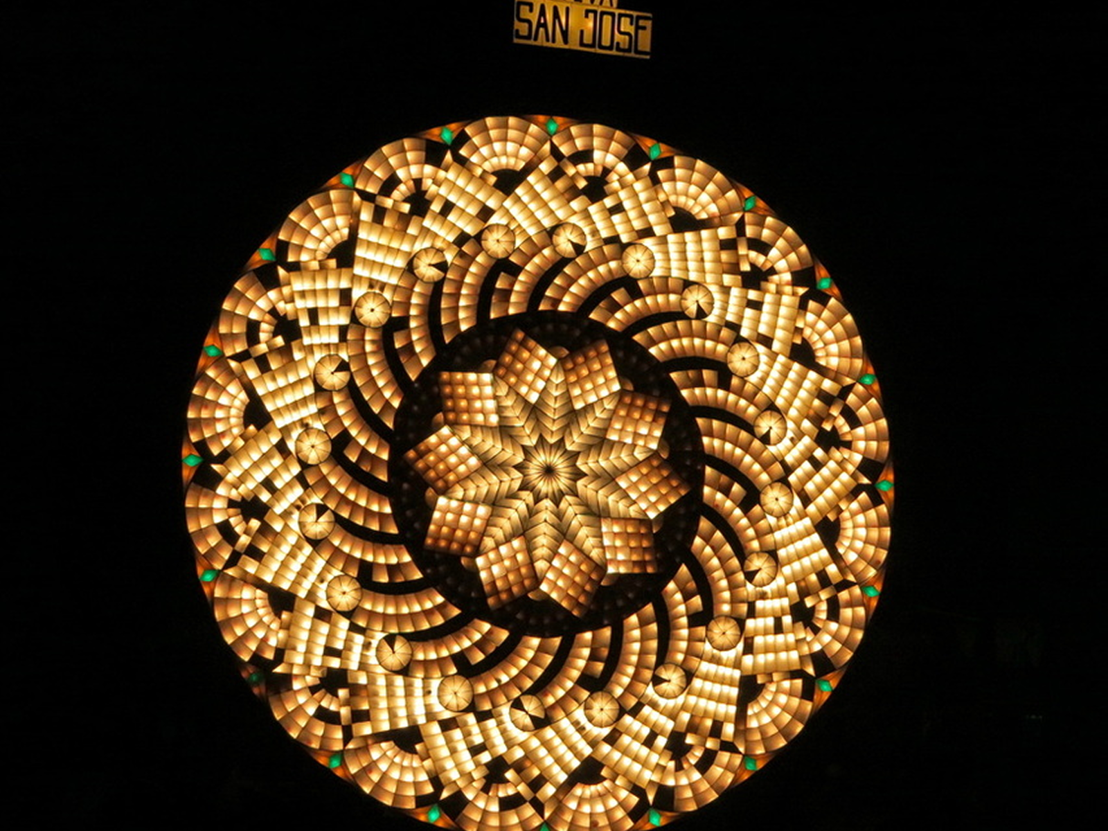 Geometric light patterns pulsing across a competition lantern