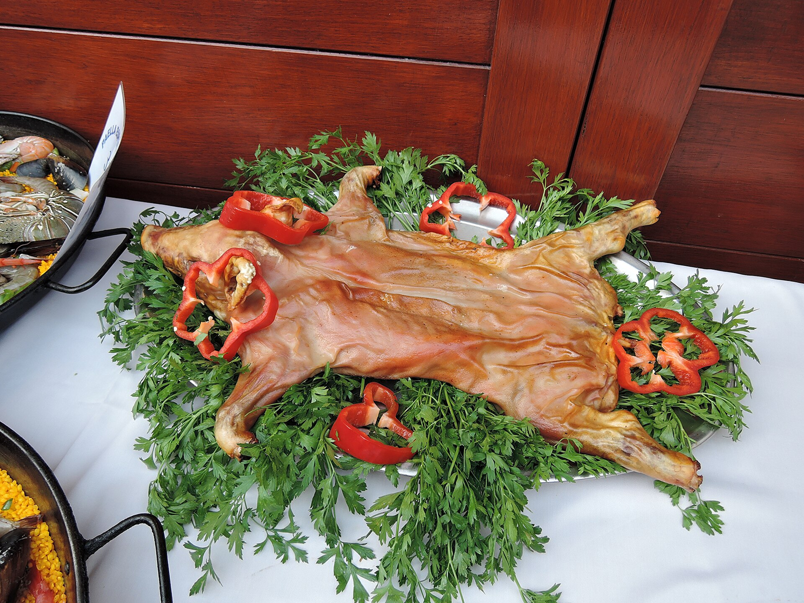 Roasted pigs and vegetables hanging from balconies