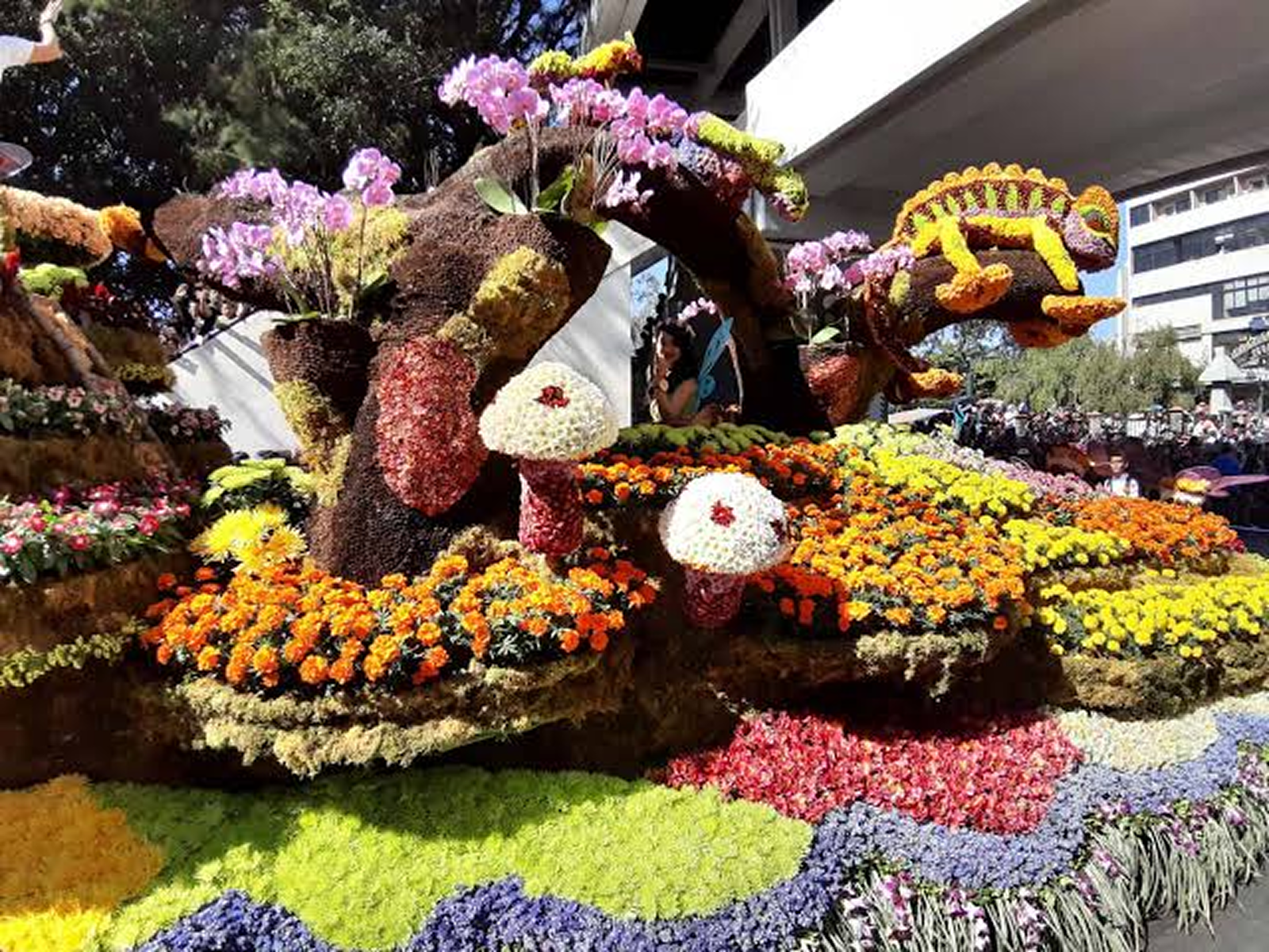 Flower covered floats moving down Session Road